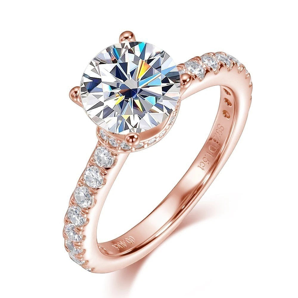 Bee-Bees 1.5ct round brilliant moissanite engagement ring in rose gold plated sterling silver with pavé band.