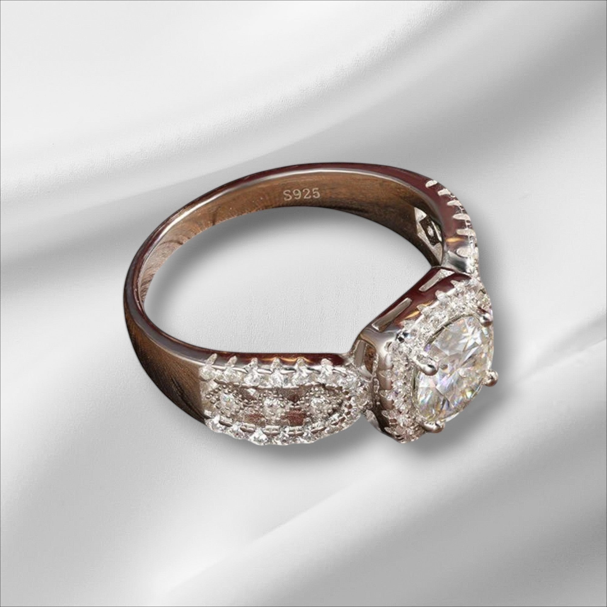 Bee-Bees 1ct D VVS1 Moissanite engagement ring in 18k white gold plated 925 silver with a halo of small stones.