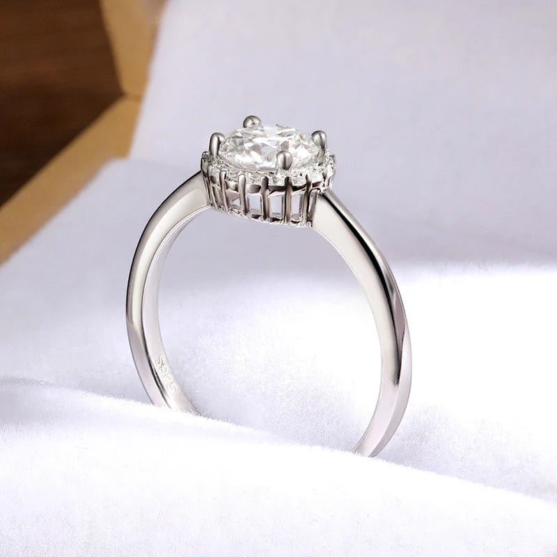 Bee-Bees 1ct round brilliant cut moissanite solitaire ring in 925 sterling silver with 18k white gold plating.