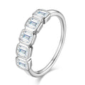 Bee-Bees 2.5ctw emerald cut moissanite 5-stone band in sterling silver with 18k gold plating.