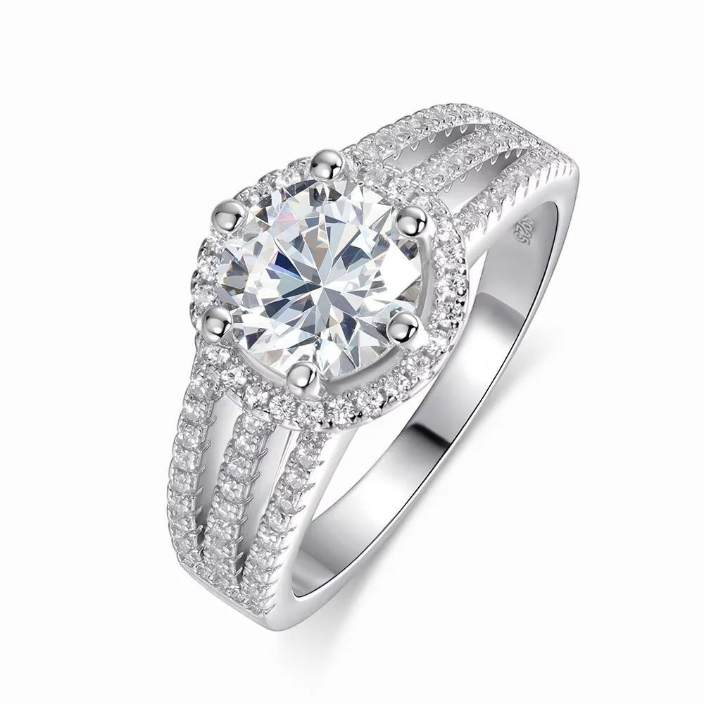 Bee-Bee's 3ct round brilliant cut moissanite engagement ring in s925 sterling silver with 18k white gold plating and halo of small stones.