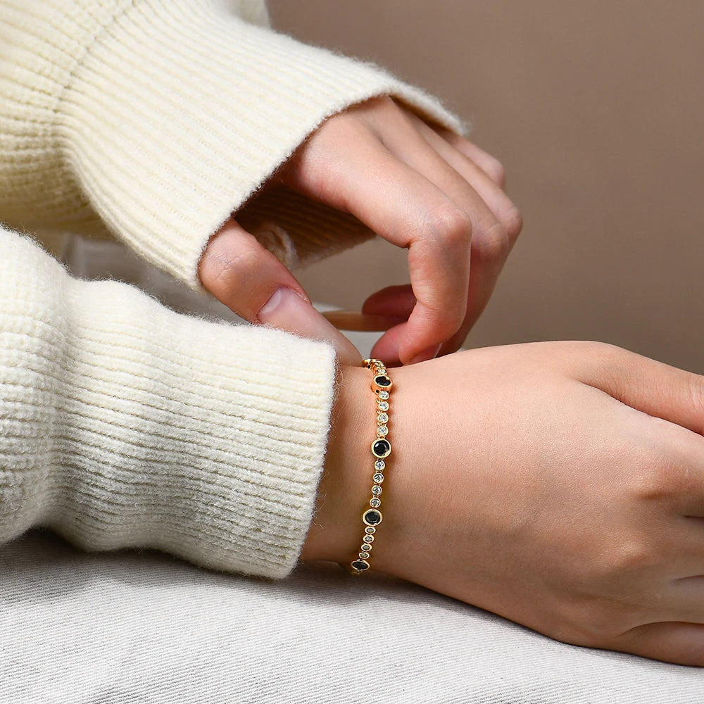 Bee-Bees black moissanite tennis bracelet in 18K gold-plated S925 sterling silver worn on a wrist