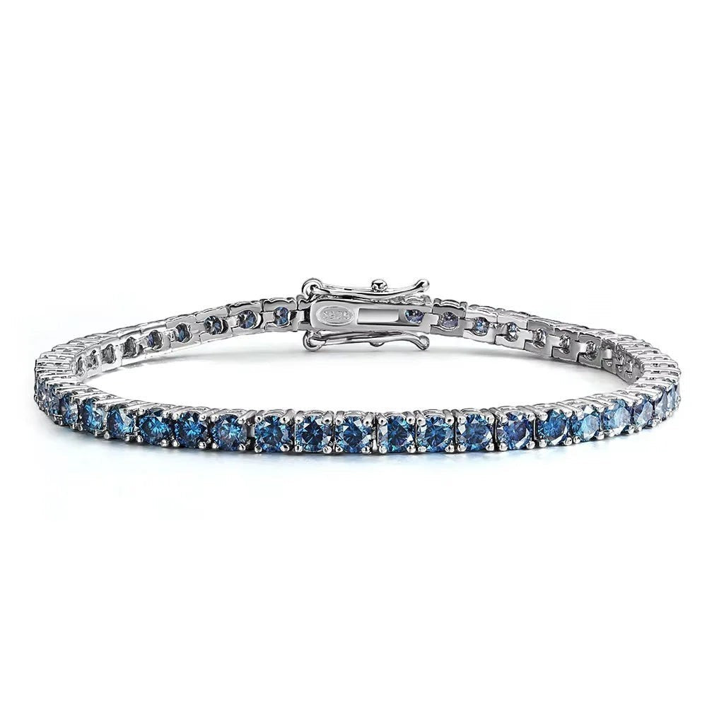 Bee-Bees blue moissanite tennis bracelet crafted from S925 sterling silver with 18k white gold plating. Features round-cut blue stones.