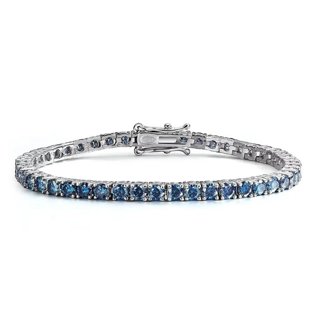 Bee-Bees blue moissanite tennis bracelet crafted from S925 sterling silver with 18k white gold plating. Features round-cut blue stones.