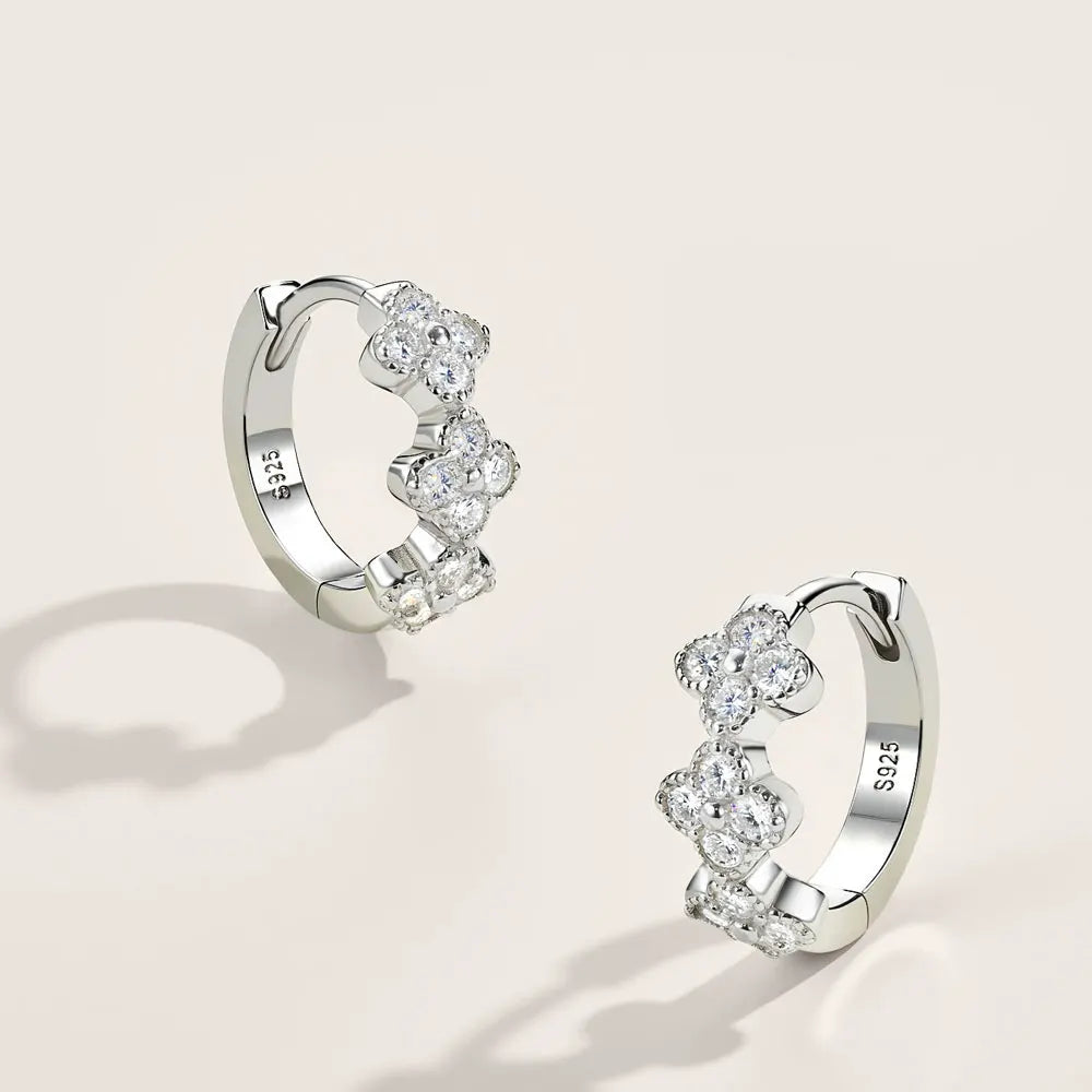 Bee-Bees four leaf clover huggie earrings in 925 sterling silver with sparkling D color moissanite stones.