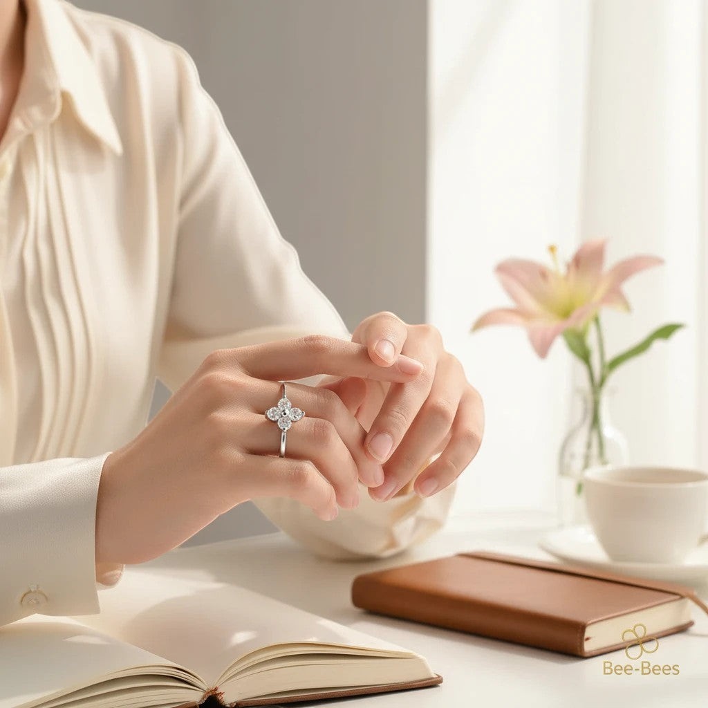 Bee-Bees sterling silver four-leaf clover ring with D color moissanite stones worn on a woman's finger