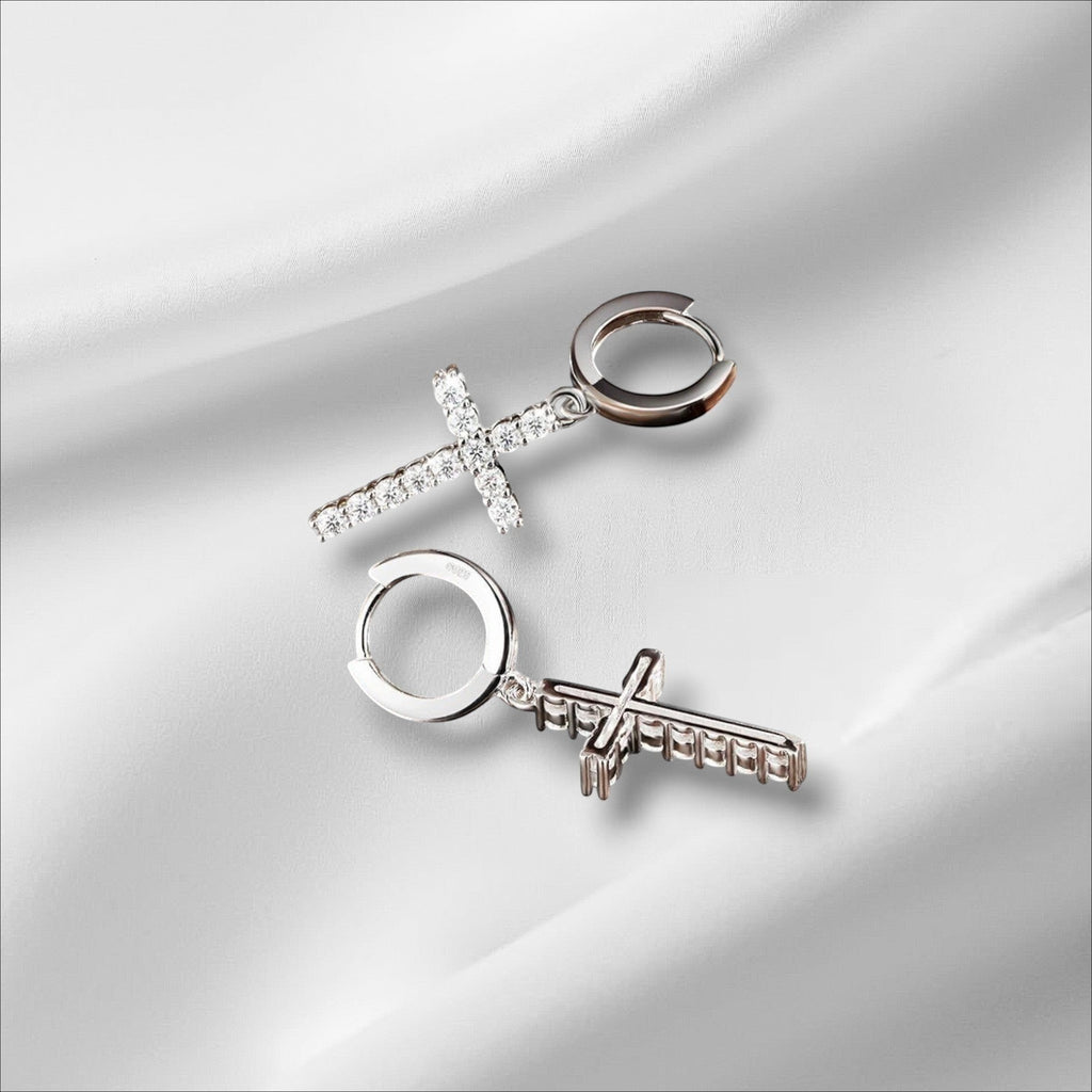 Bee-Bee's sterling silver hoop earrings with dangling cross charms encrusted with sparkling moissanite stones.