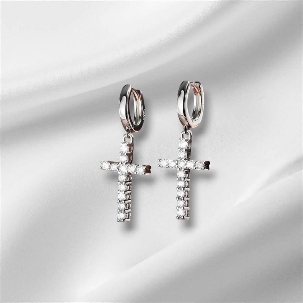 Bee-Bee's sterling silver hoop earrings with dangling cross charms encrusted with clear Moissanite stones.