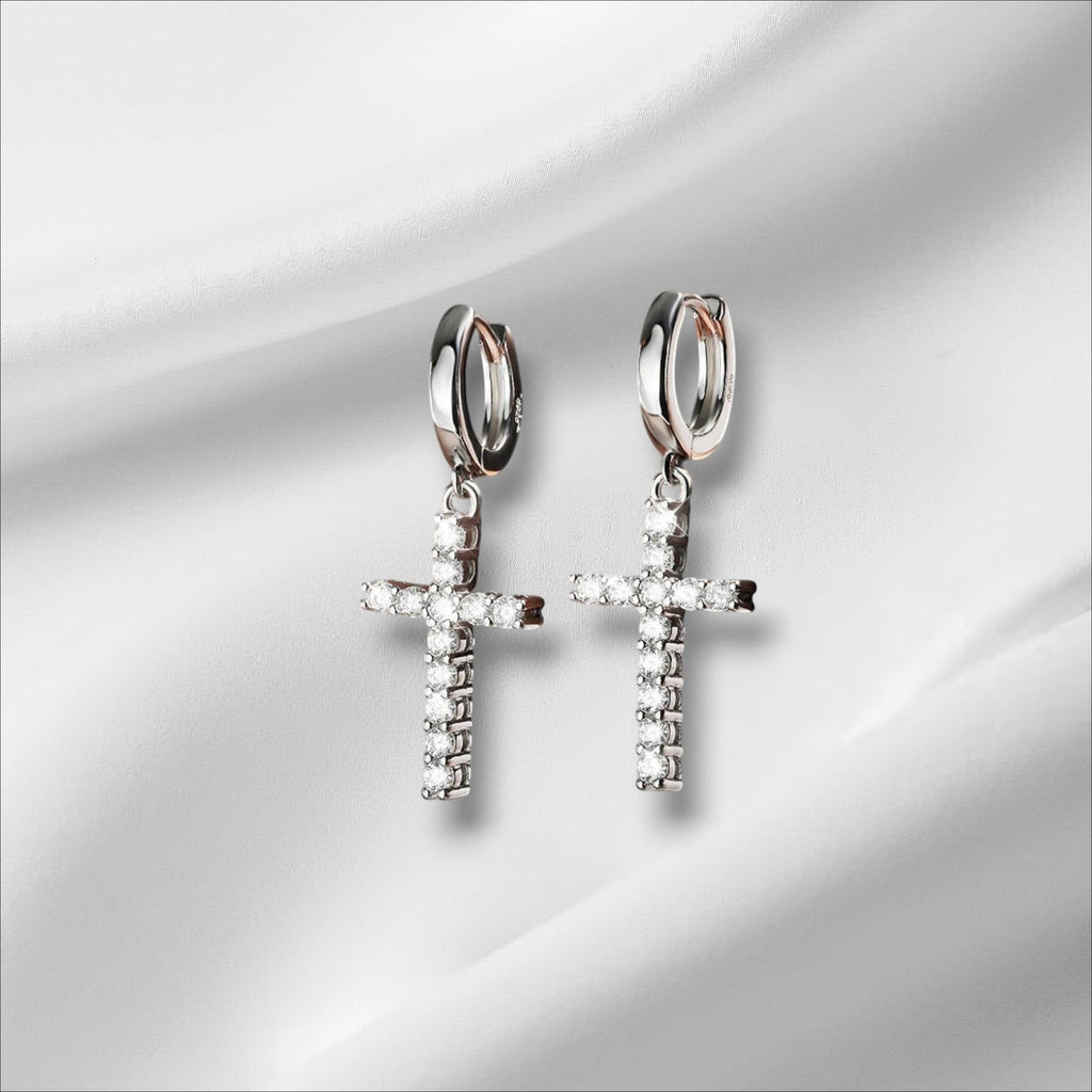 Bee-Bee's sterling silver hoop earrings with dangling cross charms encrusted with clear Moissanite stones.