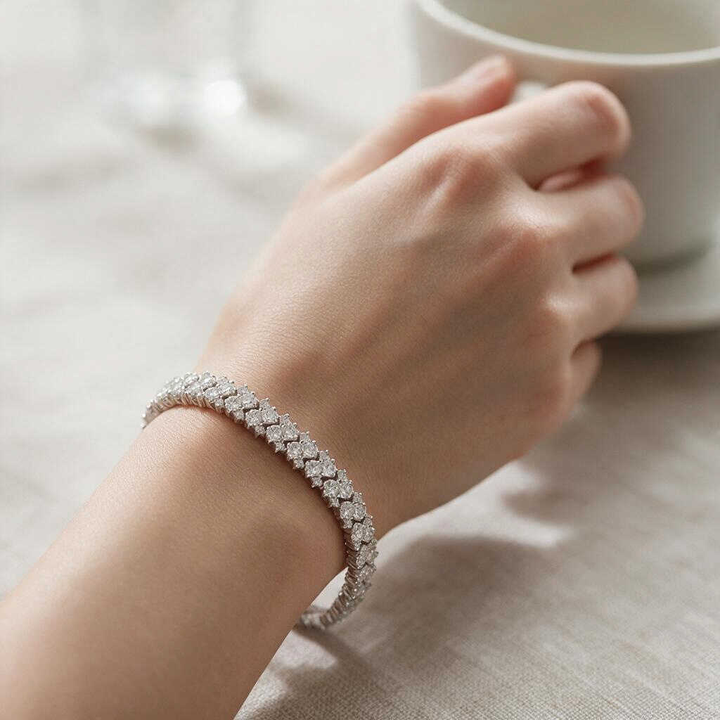 Bee-Bees double row moissanite tennis bracelet in 925 sterling silver worn on a wrist with a white coffee cup