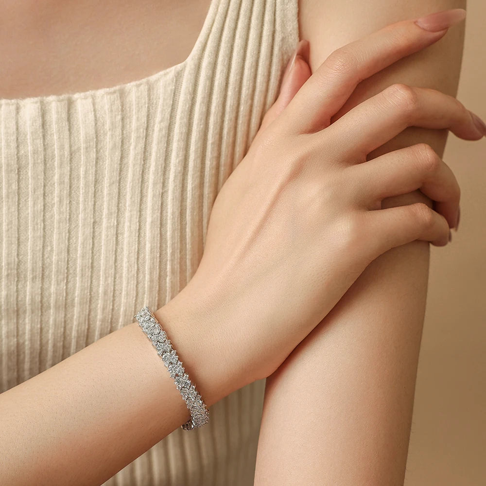 Bee-Bees double row moissanite tennis bracelet in 925 sterling silver worn on a wrist, showcasing brilliant sparkle.