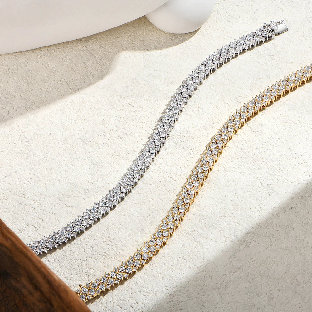 Bee-Bees double row moissanite tennis bracelets in silver and 18K gold-plated sterling silver on a textured surface.