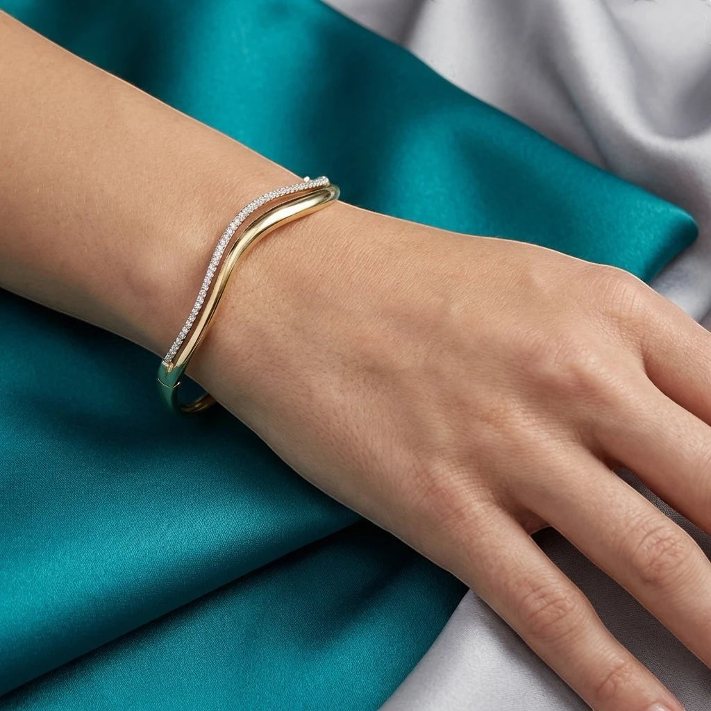 Bee-Bee's double wavy 18K gold plated sterling silver bangle with 1.5mm D Color Moissanite stones.