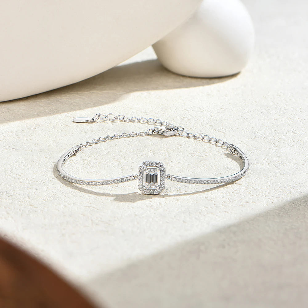 Bee-Bees emerald cut moissanite tennis bracelet in 925 sterling silver with a delicate chain and adjustable clasp.