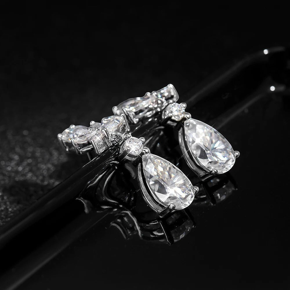 Bee-Bees Emerald cut moissanite drop earrings in sterling silver with 18k gold plating. D color, VVS1 clarity, 8.8ct total weight.