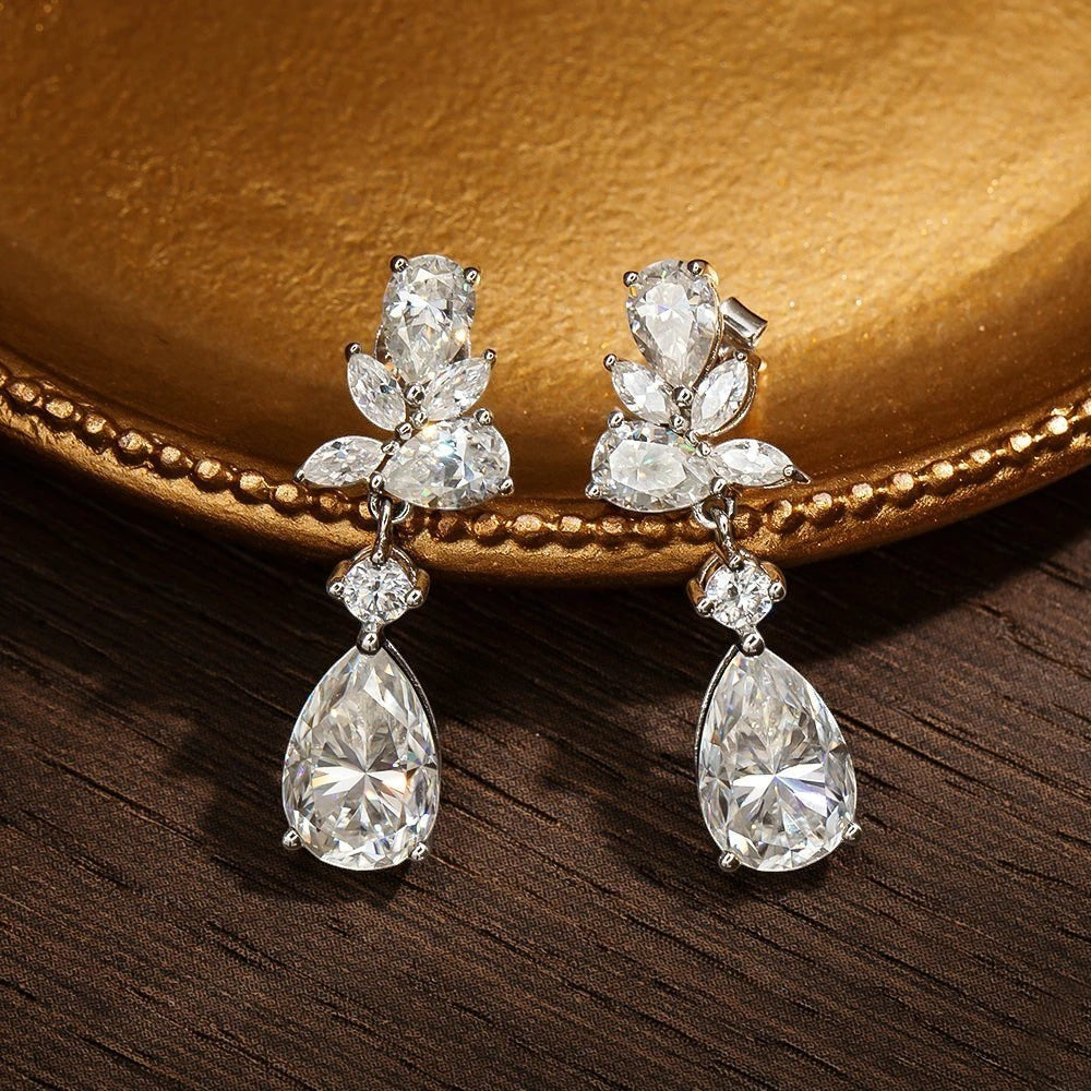 Bee-Bees 8.8ct D Color Moissanite drop earrings with emerald cut stones and 18k gold plating.