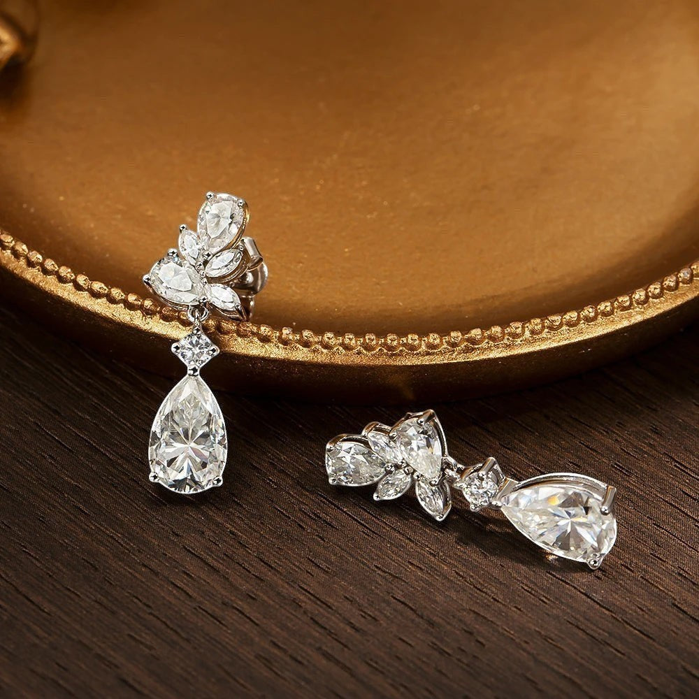 Bee-Bees Emerald cut moissanite drop earrings with 8.8ct D color stones and 18k gold plating.