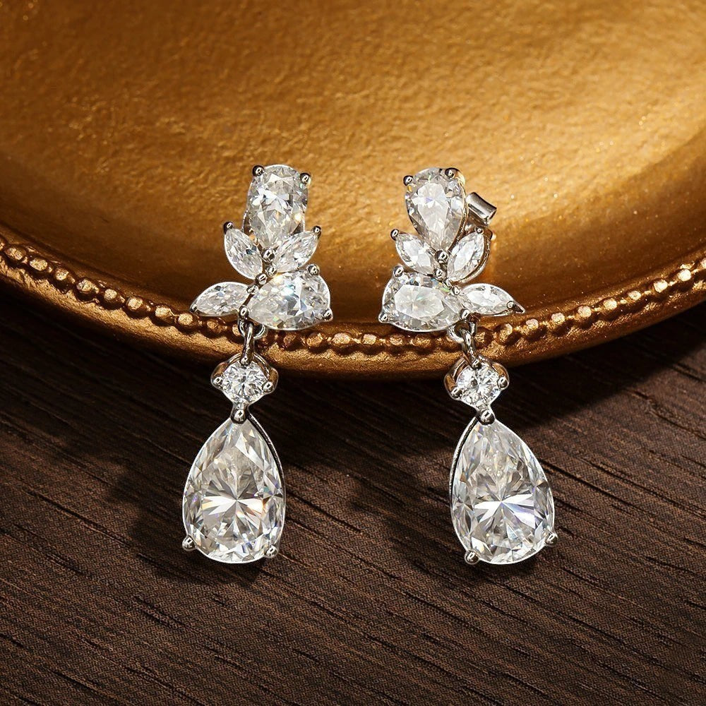 Bee-Bees 8.8ct D Color Moissanite drop earrings with emerald cut stones and 18k gold plating.