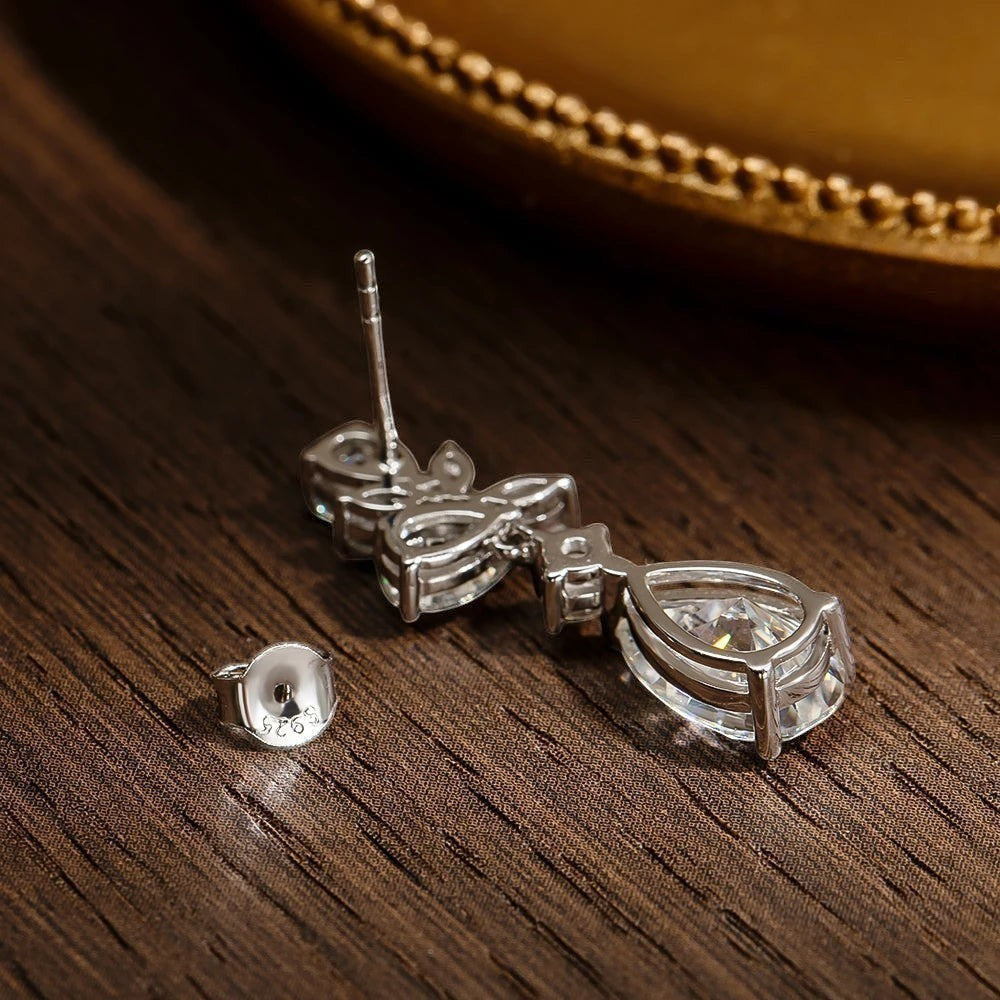 Bee-Bees Emerald cut moissanite drop earrings in sterling silver with 18k gold plating. D color, VVS1 clarity, 8.8ct.