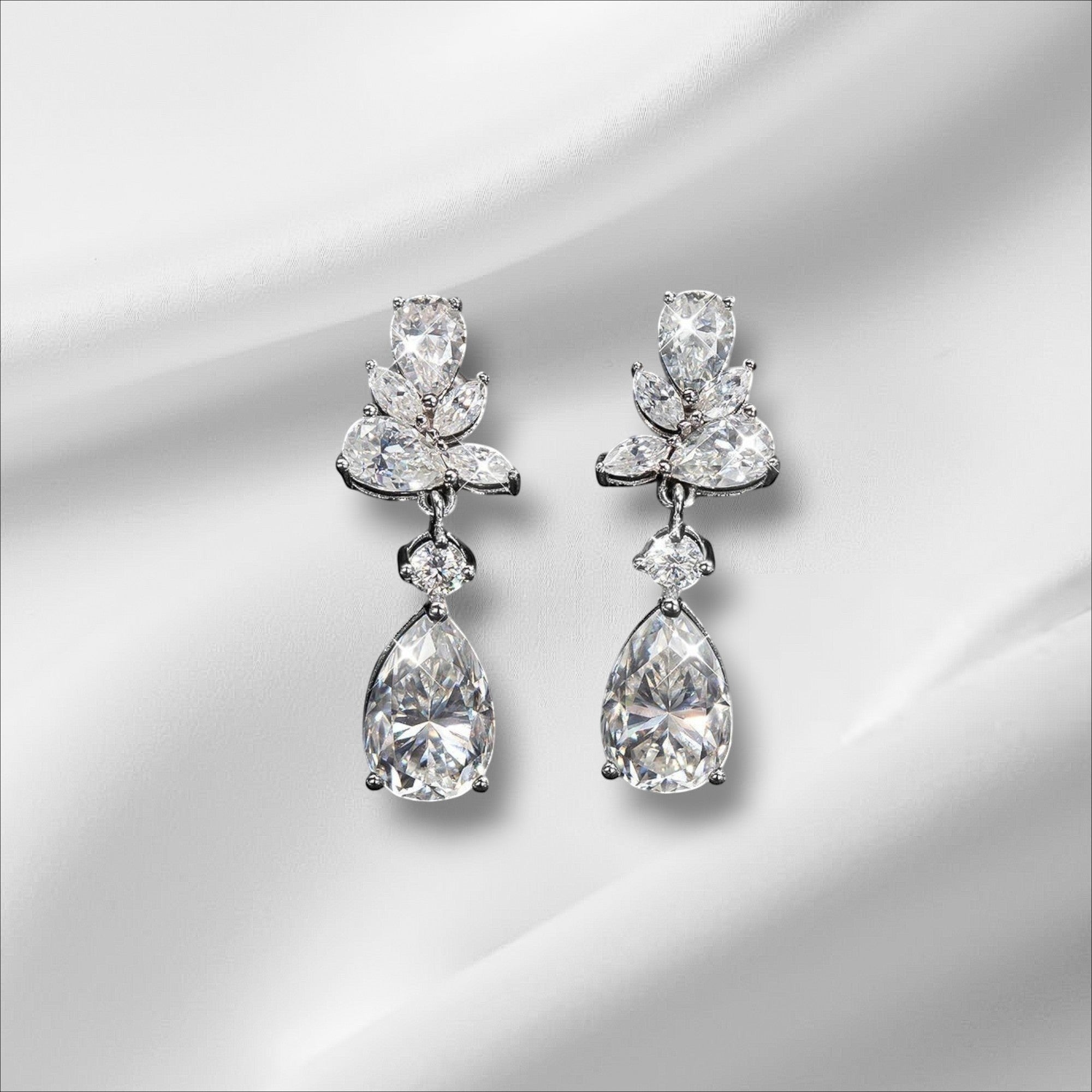 Bee-Bees Emerald Cut Moissanite Drop Earrings with 8.8ct D Color stones and 18k gold plating.