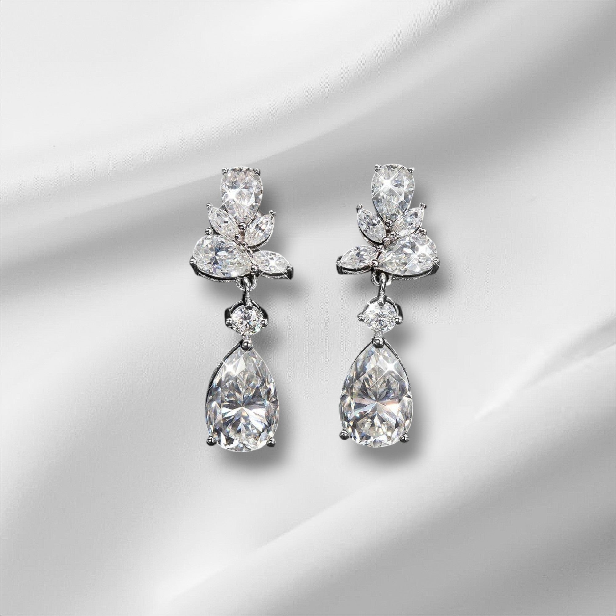 Bee-Bees Emerald Cut Moissanite Drop Earrings with 8.8ct D Color stones and 18k gold plating.