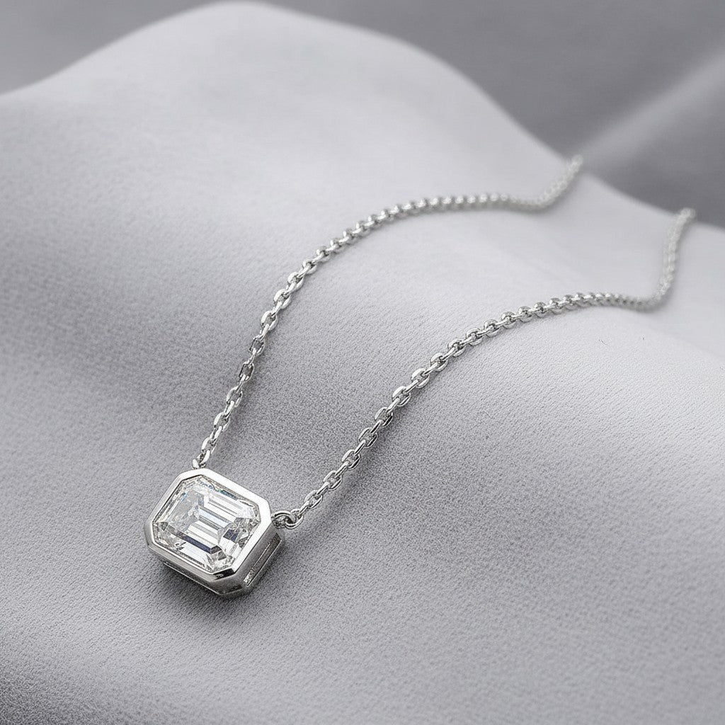 Bee-Bees 2ct emerald cut moissanite necklace with D Color GRA certified stone on a silver chain.