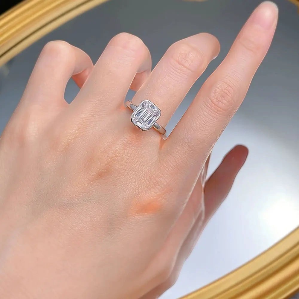 Bee-Bees 2CT emerald cut moissanite engagement ring in 18k white gold plated sterling silver with GRA certification.