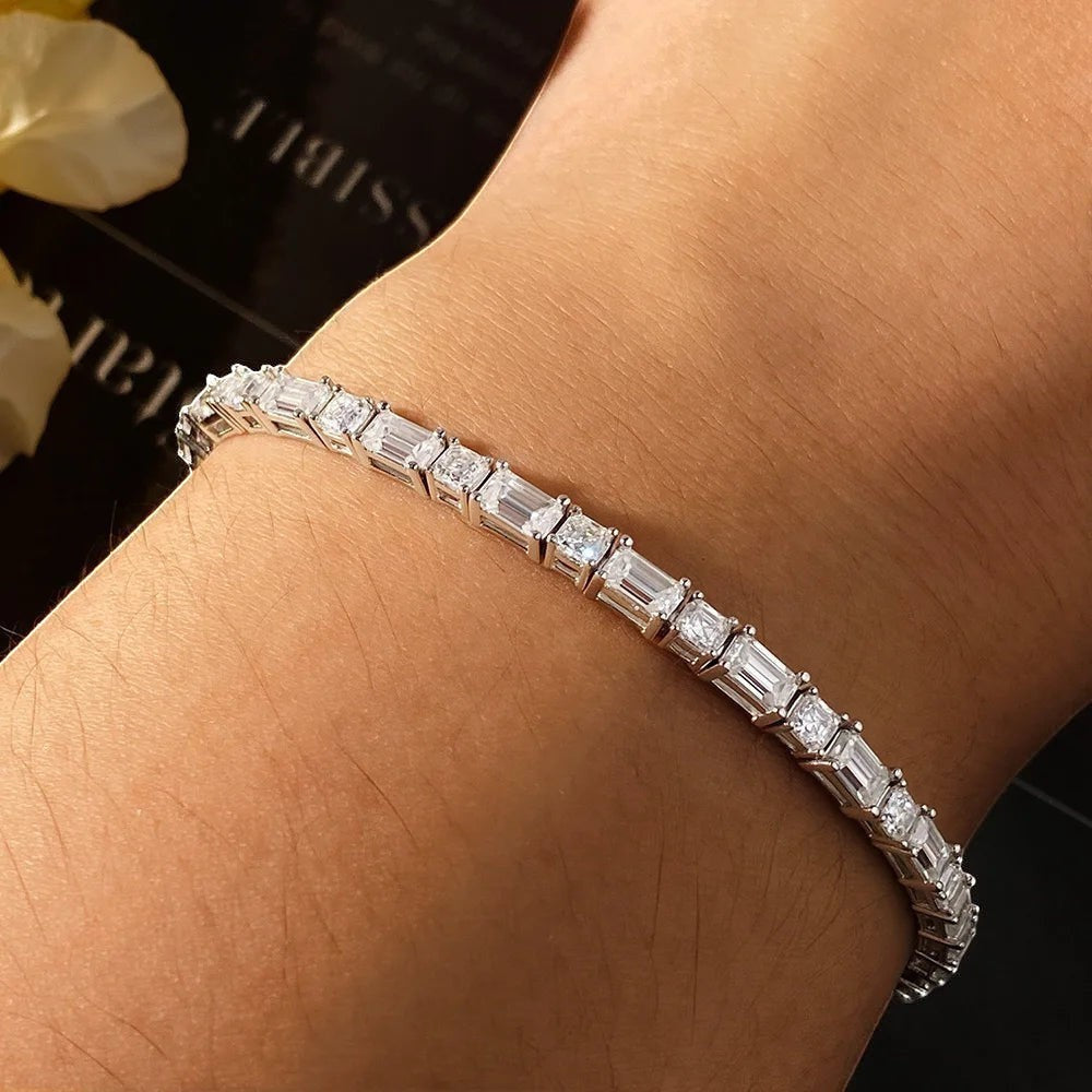 Bee-Bees Emerald cut moissanite tennis bracelet in s925 sterling silver with white gold plating. Features clear, brilliant stones.