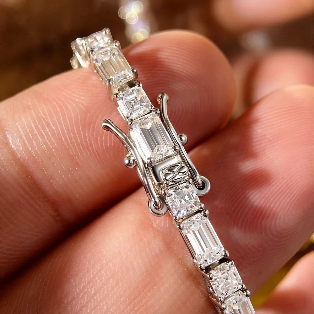 Bee-Bees sterling silver tennis bracelet with emerald-cut moissanite stones and white gold plating.
