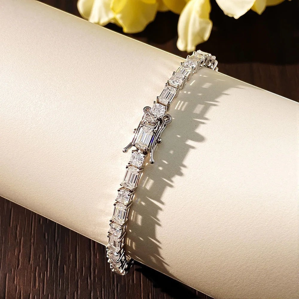 Bee-Bees Sterling silver tennis bracelet with emerald-cut Moissanite stones and white gold plating.