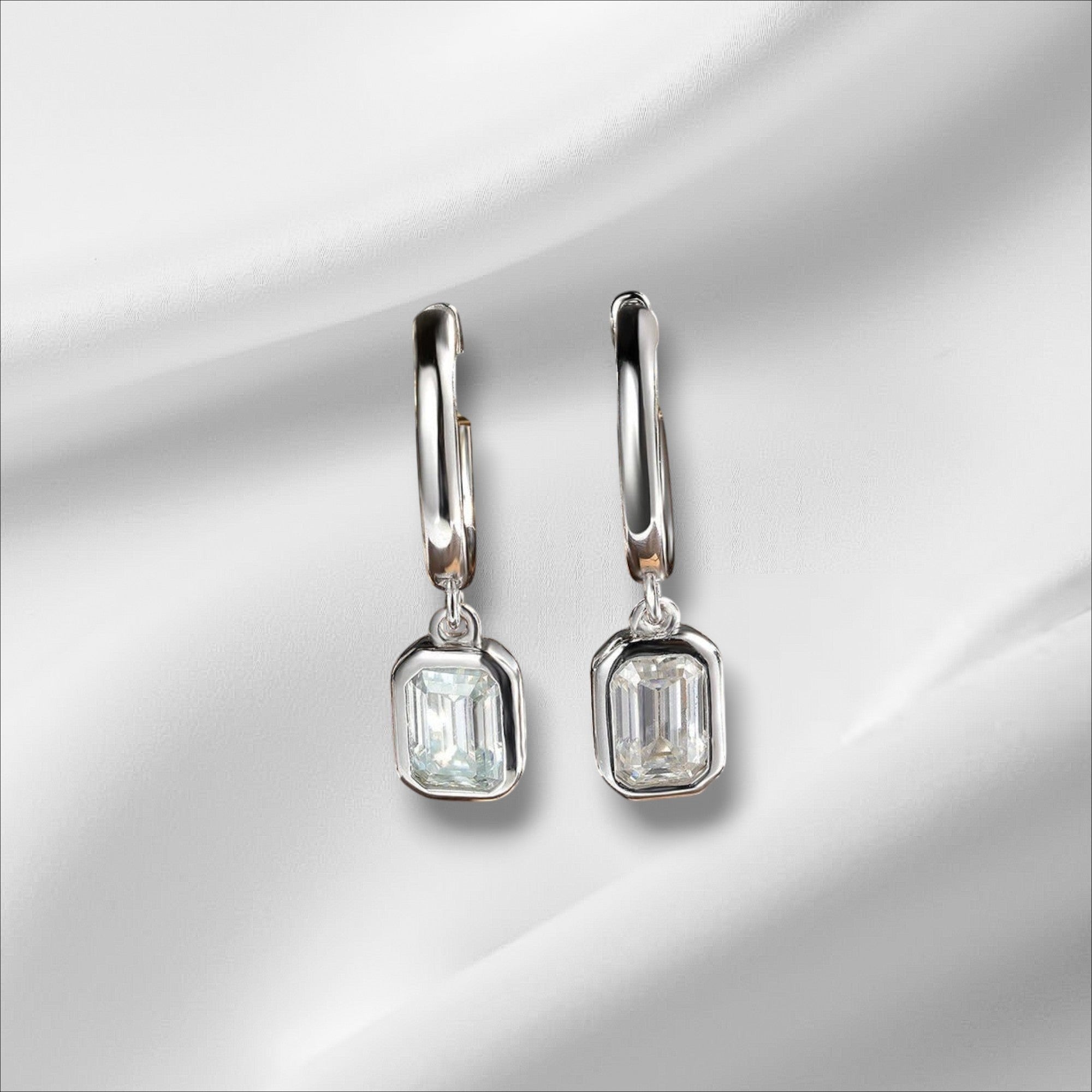 Bee-Bees D Color Emerald Moissanite Hoop Drop Earrings in 18k white gold plated sterling silver.