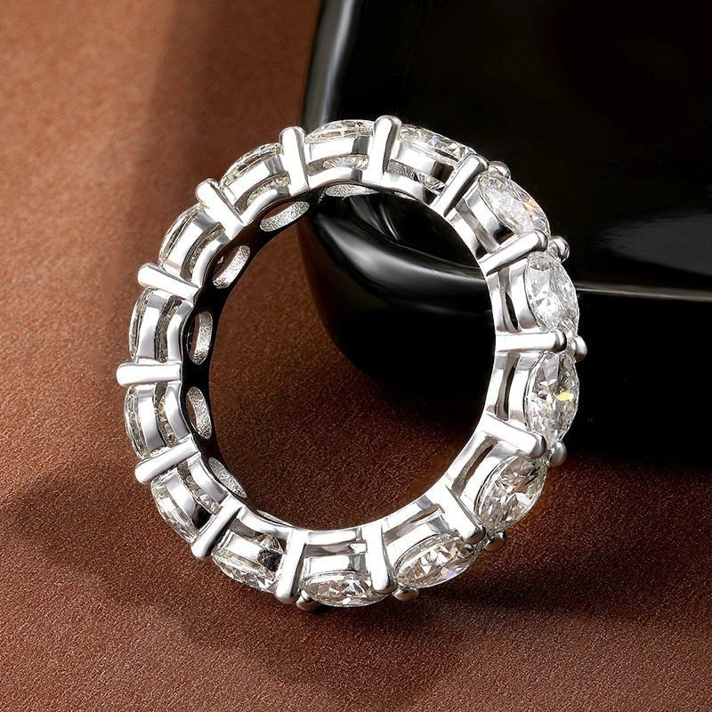 Bee-Bees full eternity moissanite band in 925 sterling silver with 7ctw D color VVS1 stones and 18k white gold plating.