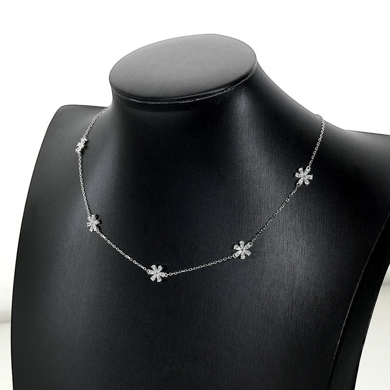 Bee-Bee's Sterling silver necklace with small flower charms set with clear stones. Delicate and elegant.