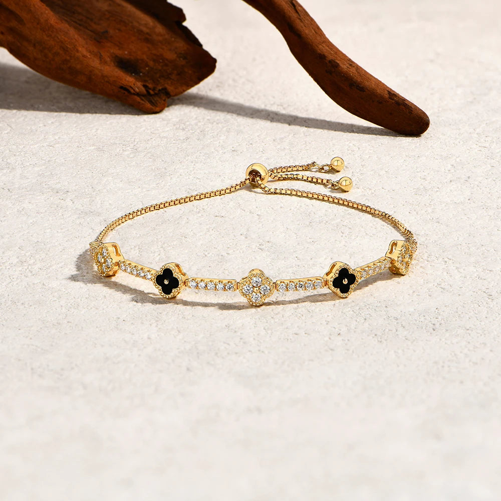 Bee-Bees 18K gold plated 925 sterling silver tennis bracelet featuring flower charms with moissanite and black inlay.