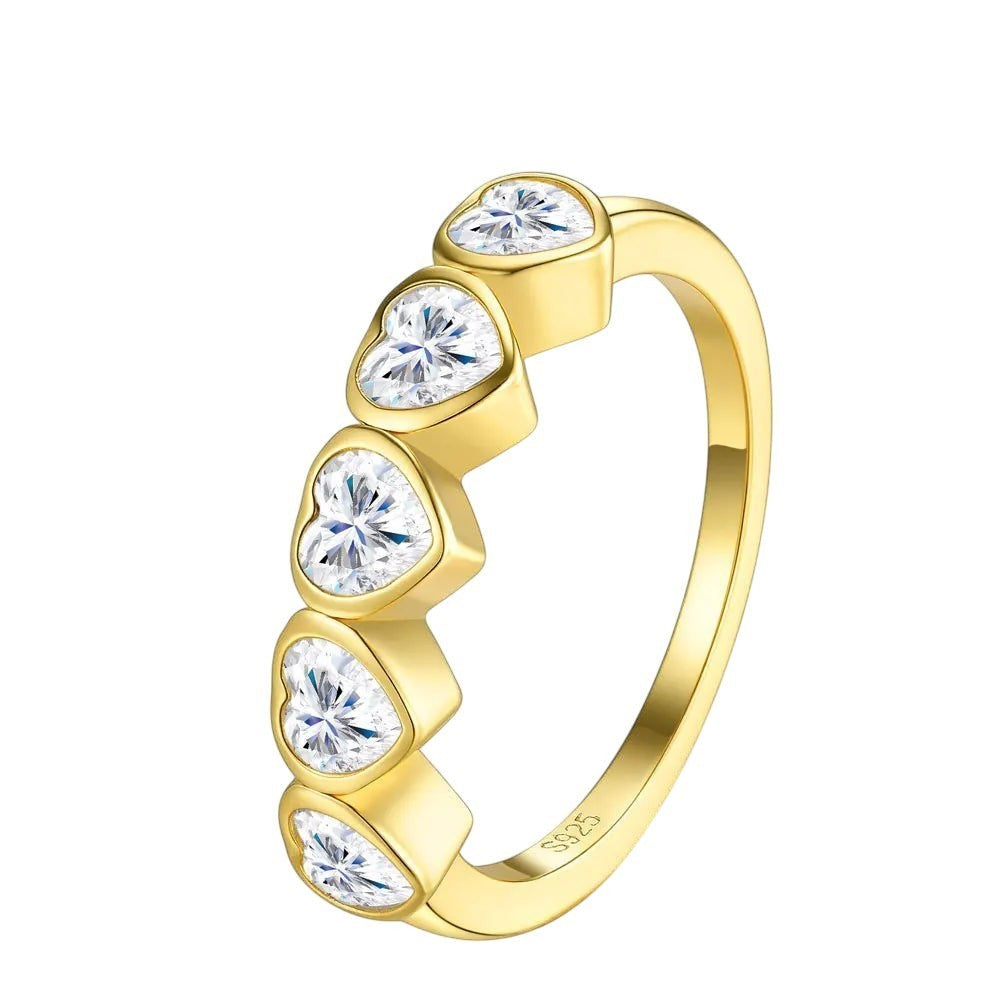 Bee-Bees heart cut moissanite anniversary band in gold-plated 925 sterling silver with five bezel-set stones.