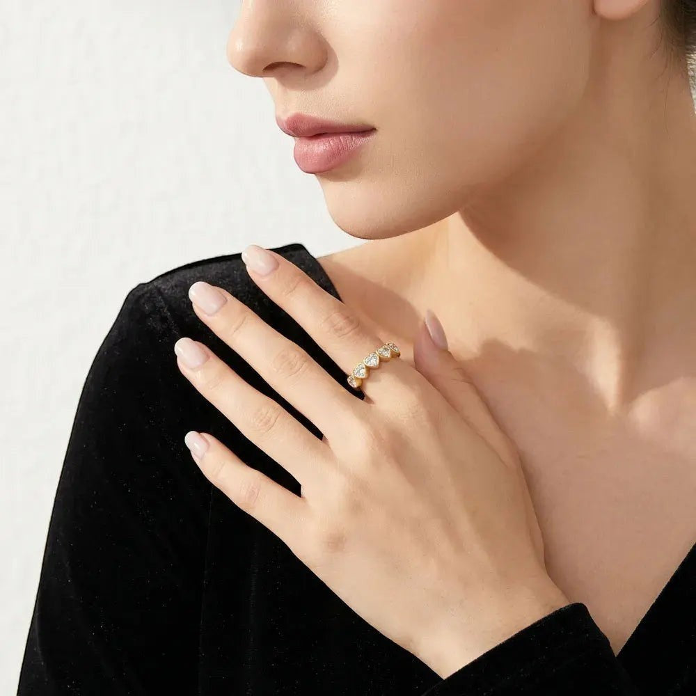 Bee-Bees heart cut moissanite anniversary band in 925 sterling silver worn on a woman's hand
