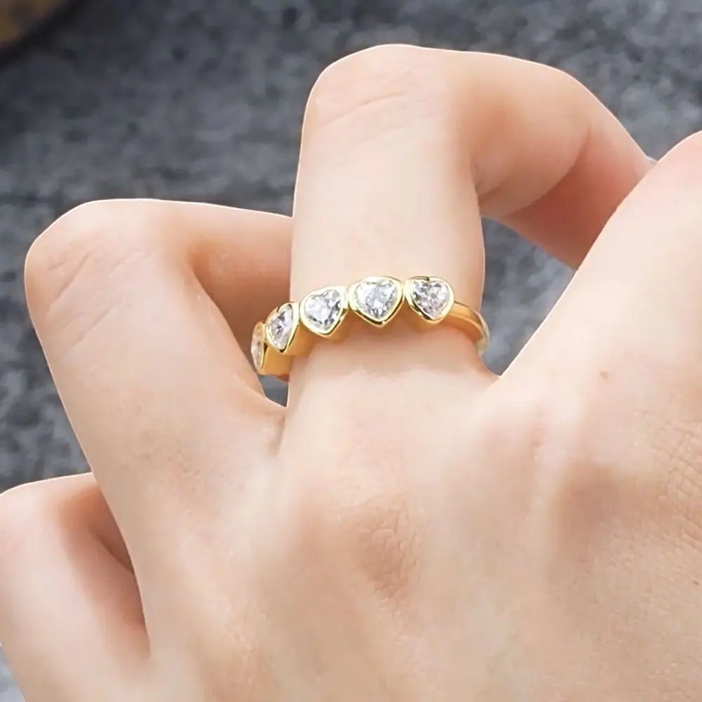 Bee-Bees heart cut moissanite anniversary band in gold-plated sterling silver worn on a finger