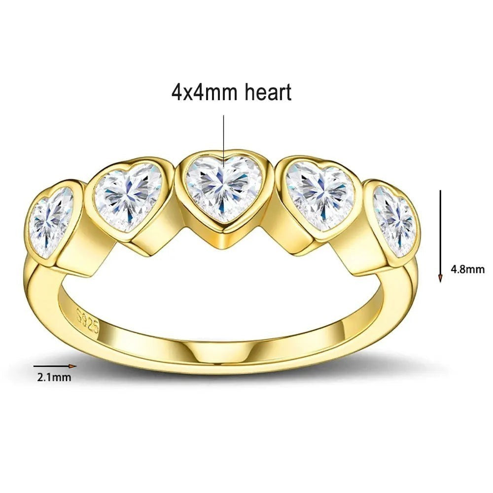 Bee-Bees heart cut moissanite anniversary band in gold-plated 925 sterling silver with five bezel-set stones.