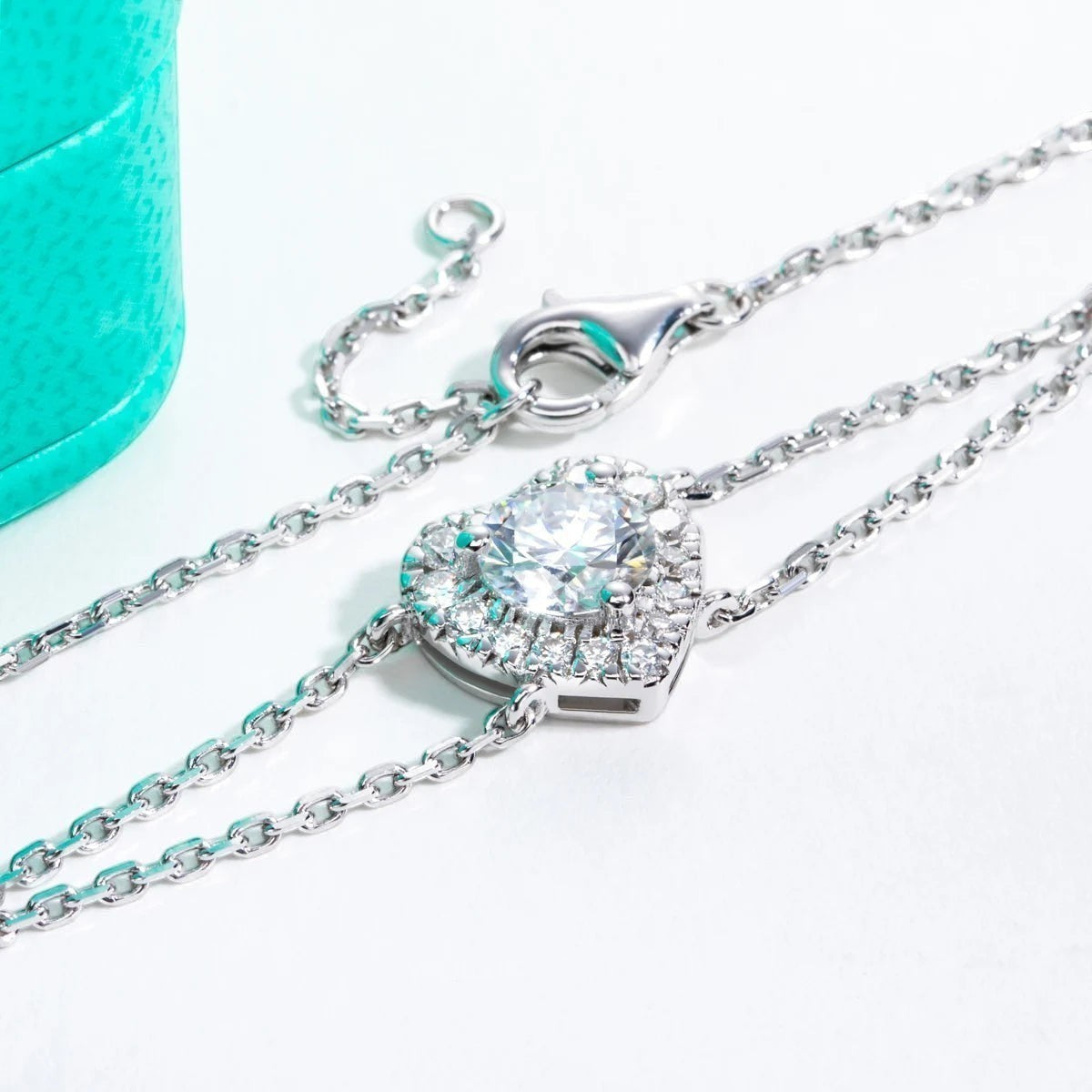 Bee-Bees 1ct heart moissanite bracelet in sterling silver with 18k gold plating. Features a D VVS1 graded heart-shaped stone surrounded by smaller stones.