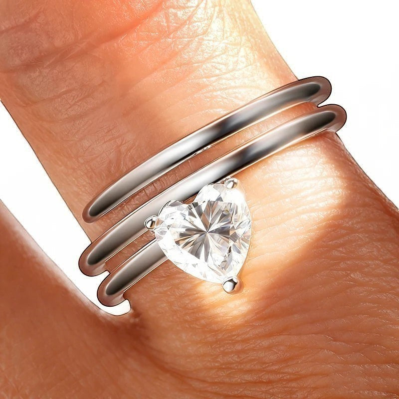 Bee-Bees sterling silver spiral eternity ring with a 1ct heart-cut moissanite center stone.