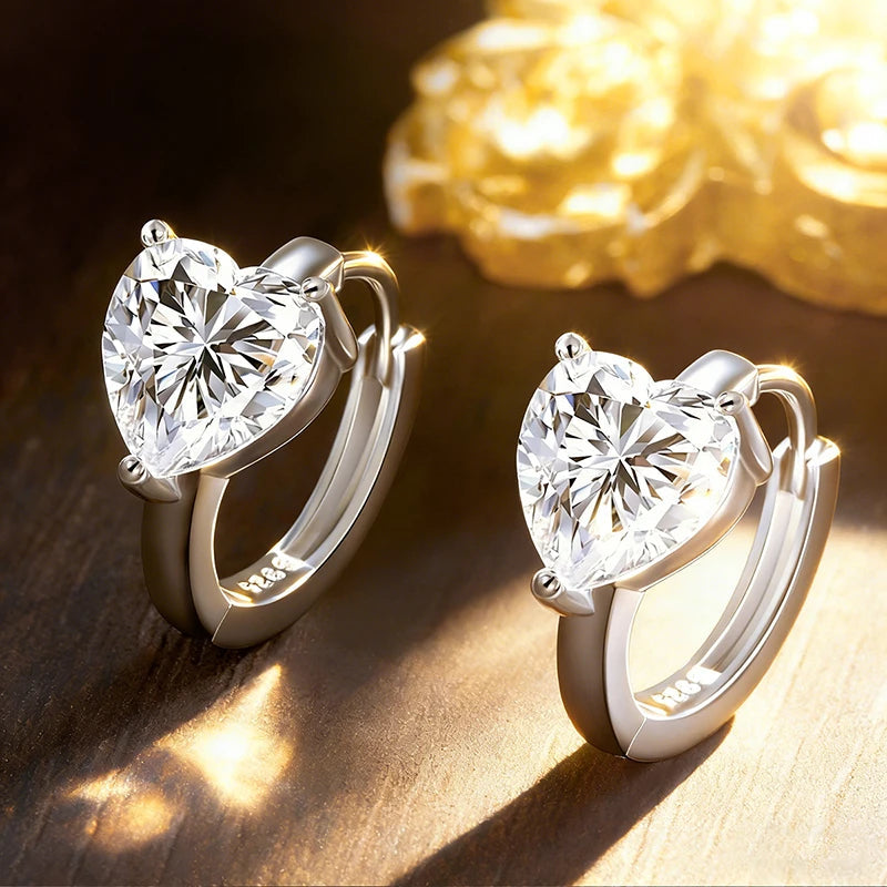 Bee-Bees 1CT heart-cut moissanite huggie hoop earrings in 925 sterling silver with 18K white gold plating.