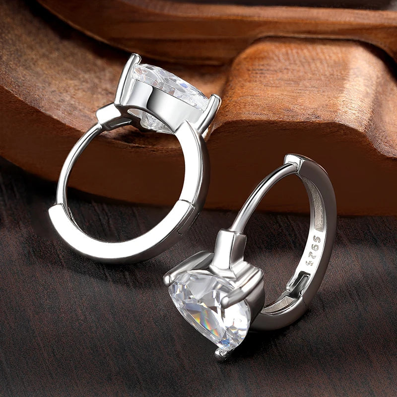 Bee-Bees 1CT heart-cut moissanite huggie hoop earrings in 925 sterling silver with 18K white gold plating.