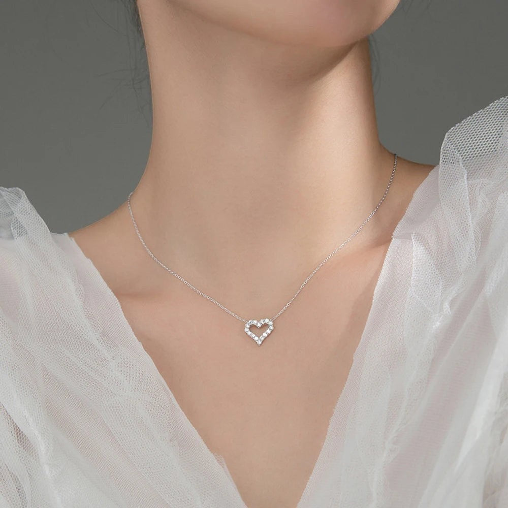 Bee-Bees sterling silver necklace with a heart-shaped pendant encrusted with clear moissanite stones.