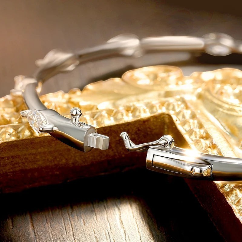 Bee-Bee's 18k white gold plated sterling silver bangle with 5 marquise cut moissanite stones and secure clasp.