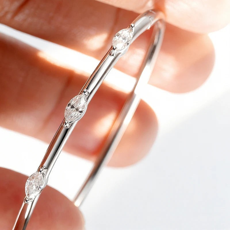 Bee-Bee's 18k white gold plated sterling silver bangle with 5 marquise-cut moissanite stones.