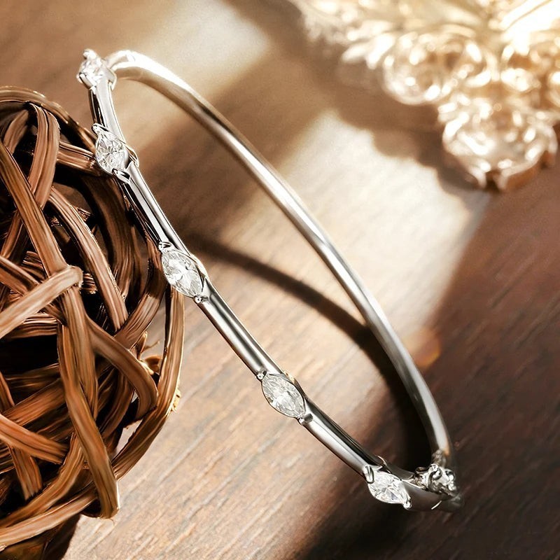 Bee-Bee's 18k white gold plated sterling silver bangle with 5 marquise-cut moissanite stones.