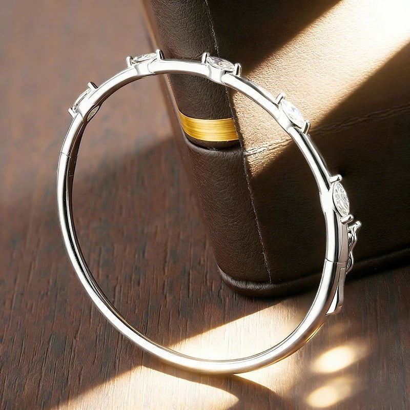 Bee-Bee's 18k white gold plated sterling silver bangle with 5 marquise-cut moissanite stones.
