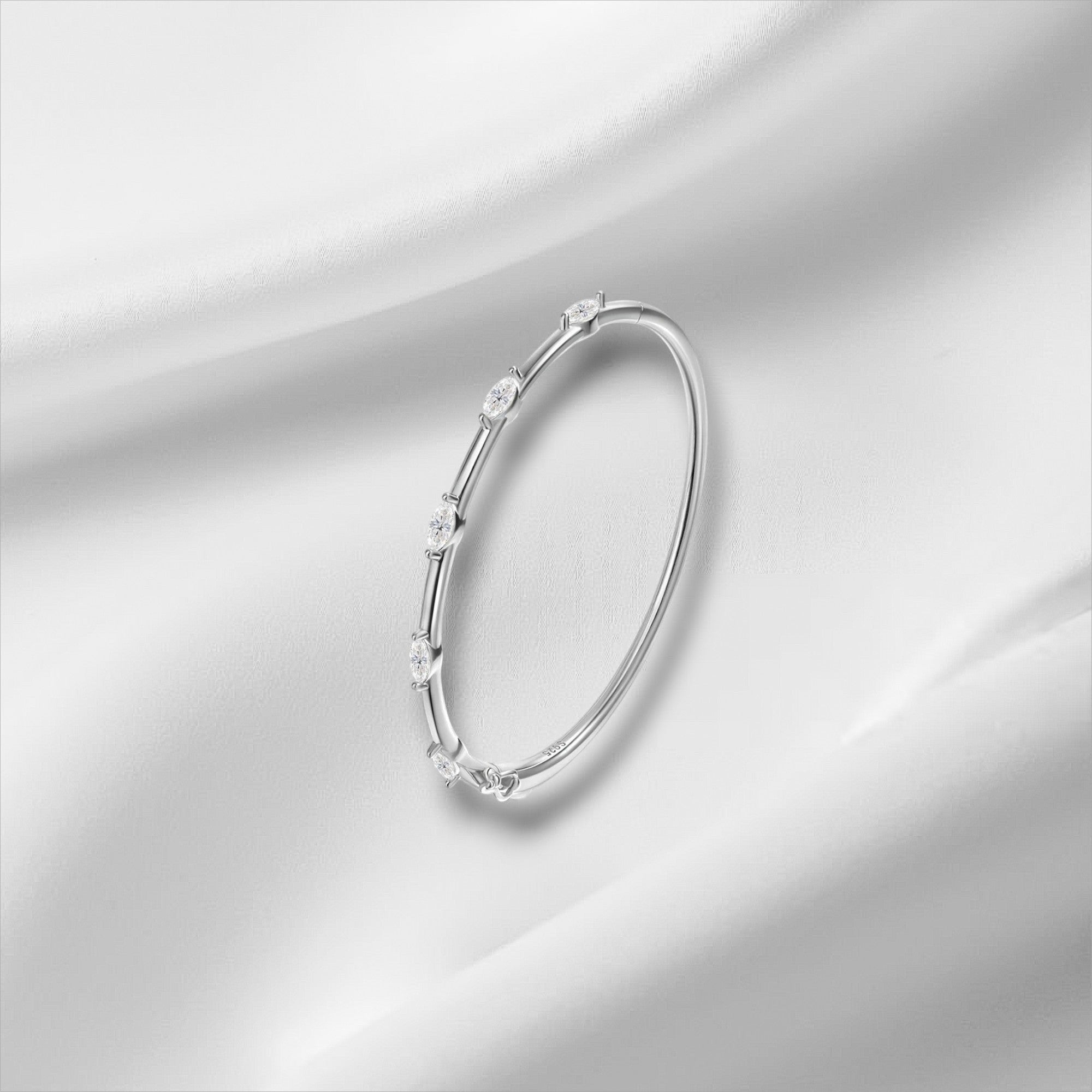 Bee-Bee's 18k white gold plated sterling silver bangle with 5 marquise-cut moissanite stones.