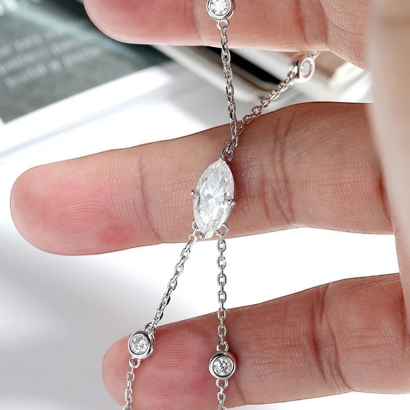 Bee-Bees Marquise cut moissanite finger bracelet in s925 sterling silver with 18k gold plating. Features a 2ct D VVS1 stone and GRA certificate.
