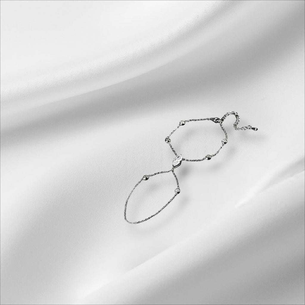 Bee-Bees sterling silver hand chain bracelet with marquise cut moissanite and small accent stones.